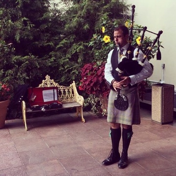 Matty Taylor preparing to play the bagpipes for a wedding ceremony